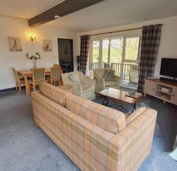 A living room with seating area and dining table at Forest Retreat Sleeps 4 2Bed with Parking Woolsery near Bideford