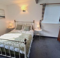 A bedroom with a bed and bedside tables at Forest Retreat Sleeps 4 2Bed with Parking Woolsery near Bideford