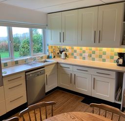A kitchen with cabinets and appliances at House Sleeps 8 Close to Beach Free parking, Mullion
