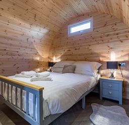 A bedroom with a bed and bedside table at The Lodge at Brambles Farm Sleeps 4 Hot Tub in Leek