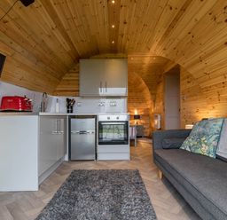 A kitchen with a sofa and appliances at The Lodge at Brambles Farm Sleeps 4 Hot Tub in Leek