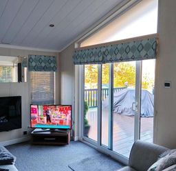 A living room with a television and sliding door at Dunoon 3Bed Lodge Sleeps 6 Pet Friendly near Dunoon