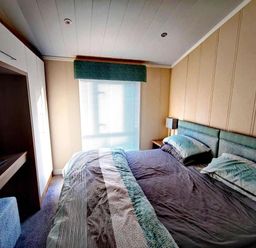A bedroom with a bed and television at Dunoon 3Bed Lodge Sleeps 6 Pet Friendly near Dunoon