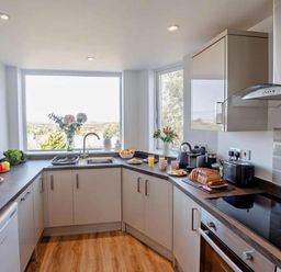 A kitchen with modern appliances and a fruit bowl at Cottage Sleeps 5 with Parking and Garden in Carreglefn