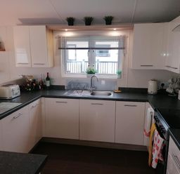 A kitchen with sink and appliances at Seaside Lodge Retreat in Eyemouth