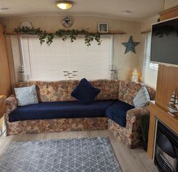A living room with a sofa and coffee table at Sandy Paws Dog Friendly Anderby Creek