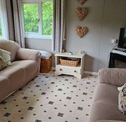 A living room with sofas and a television at the property in Builth Wells