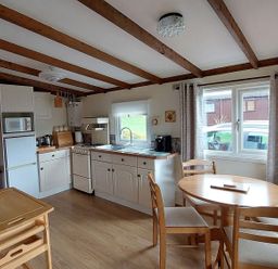 A kitchen with a table and chairs at The Old Barn in Builth Wells