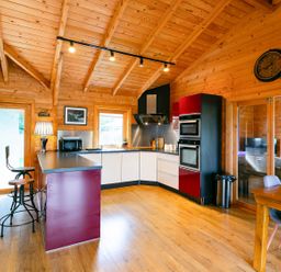 A kitchen with bar stools and modern appliances at the property location