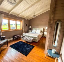 A bedroom with a bed and chair at The Old Barn in Manchester