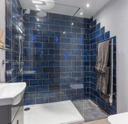 A bathroom with shower, sink, toilet and towel rack at 1Bed Coastal Retreat Sleeps 2 Parking Wifi Bude