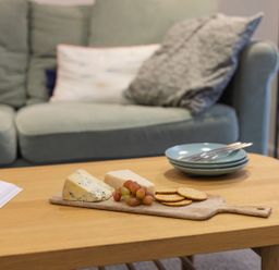A living room with cheese and grapes on a table at 1Bed Coastal Retreat Sleeps 2 Parking Wifi in Bude