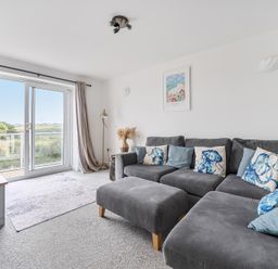 A living room with a sofa and television at Spacious 3 Bed House Sleeps 6 Parking Wifi Newquay
