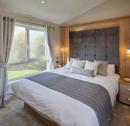 A bedroom with a bed and window at 2Br Lodge Pool Fireplace PetsOK Parking in Goonhavern
