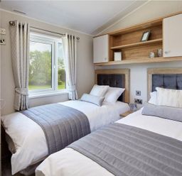 A bedroom with two beds and a window at 2Br Lodge Pool Fireplace PetsOK Parking in Goonhavern