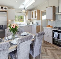 A kitchen with a dining table and chairs at 2Br Lodge Pool Fireplace PetsOK Parking in Goonhavern