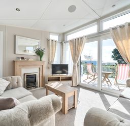 A living room with a sofa and television at 2Br Lodge Pool Fireplace PetsOK Parking in Goonhavern