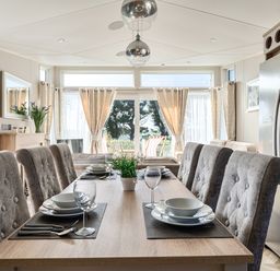 A dining room with a table set for meals at 2Br Lodge Pool Fireplace PetsOK Parking in Goonhavern