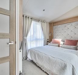 A bedroom with a bed and window at 2Br Lodge Pool Fireplace PetsOK Parking in Goonhavern