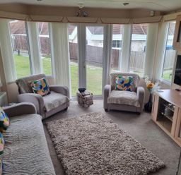 A snug with sofas and a television at Chalet Sleeps 6 swimming pool Thorness Bay