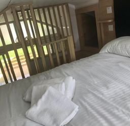 A bedroom with a bed and towels at Selfcatering Lodge Inverness Sleeps 4 Inverness