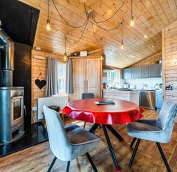 A kitchen with a dining table and stove at Alpaca Farm Valley Views Sleeps 4 Parking Pets Husthwaite