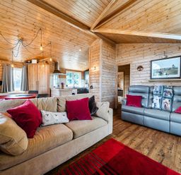 A living room with a sofa and dining area at Alpaca Farm Valley Views Sleeps 4 Parking Pets Husthwaite