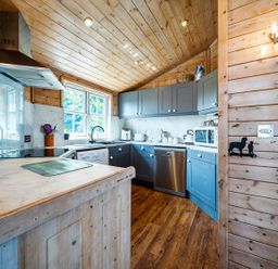 A kitchen with cabinets and appliances at Alpaca Farm Valley Views Sleeps 4 Parking Pets Husthwaite