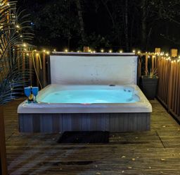 A hot tub on a deck surrounded by lights at Felmoor Park Northumberland Lodge with Hot Tub Felmoor Park near Felton