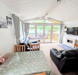 A living room with a sofa, dining table and television at Felmoor Park Northumberland Lodge with Hot Tub, Felmoor Park near Felton