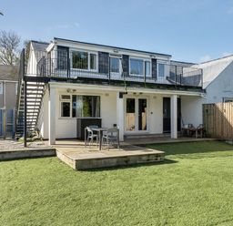 An outdoor area featuring a house with a balcony and seating at 1 Bedroom Apartment Sleeps 2 Pets Welcome in Carbis Bay