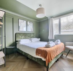 A bedroom with a bed and chair at 1 Bedroom Apartment Sleeps 2 Pets Welcome in Carbis Bay