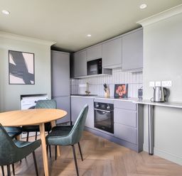 A kitchen with a table and chairs at 1 Bedroom Apartment Sleeps 2 Pets Welcome in Carbis Bay