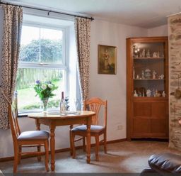 A dining area with table and chairs at the property in an unspecified location