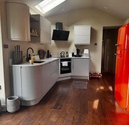 A kitchen with modern appliances and light cabinetry at 
