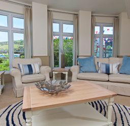 A living room with sofas and a coffee table at 4 The Salcombe in Salcombe