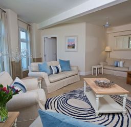 A living room with sofas and a coffee table at 4 The Salcombe in Salcombe