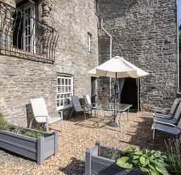 An outdoor area with a table and chairs at Dewi Villa Apartment in Aberaeron