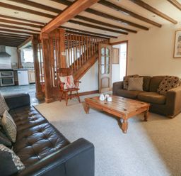 A living room with sofas and a coffee table at Dewi Villa Apartment in Aberaeron