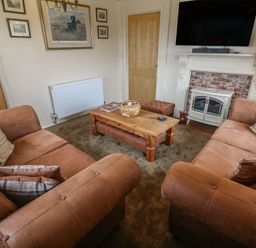 A living room with sofas and a coffee table at The Hideaway at Monterey Helston