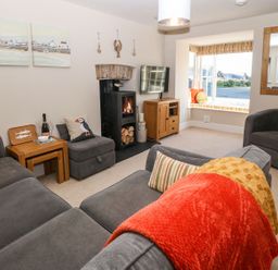 A living room with a sofa and television at Bryn Tirion - Rhosneigr