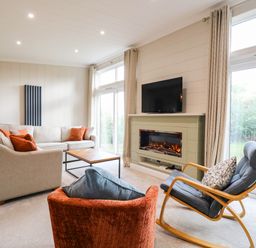 A living room with a sofa and television at Cherry Lodge Battisford near Stowmarket