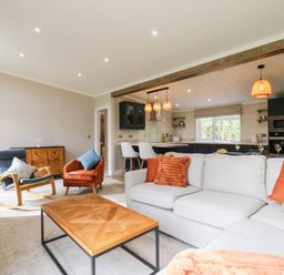 A living room with a sofa and coffee table at Cherry Lodge Battisford near Stowmarket