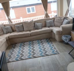 A snug with a sofa and rug at Golden Sands FSB38 in Rhyl