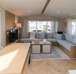 A living room with a sofa and coffee table at 5 Rowen Court in Scarborough