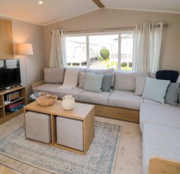 A living room with a sofa and television at 5 Rowen Court in Scarborough