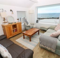A living room with a coffee table and two sofas at Y Glyn in Borth