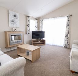 A living room with a sofa and television at Rosella 38 Morecambe