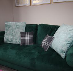 A couch with decorative pillows in a living room at Brinkburn House, Scarborough