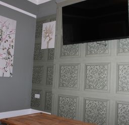 A living room with a television and wall art at Blackburn Heights Apartment 1 in Bridlington